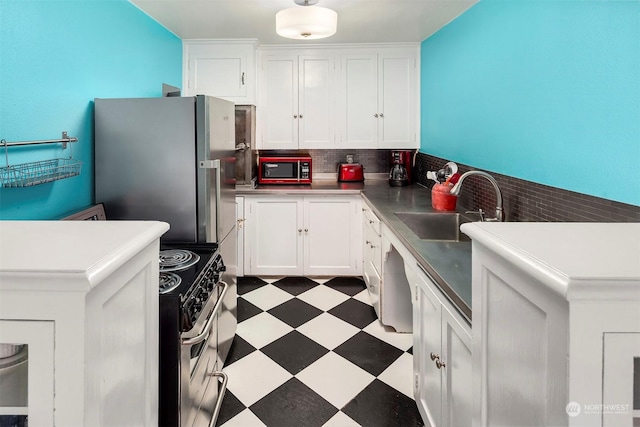 kitchen featuring sink, white cabinets, decorative backsplash, and appliances with stainless steel finishes