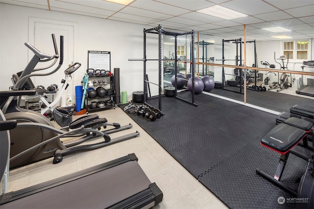 workout area with a paneled ceiling