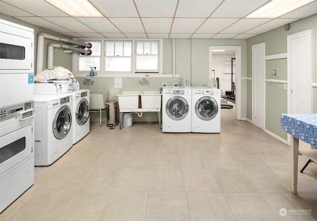 washroom with sink, stacked washer / drying machine, and independent washer and dryer