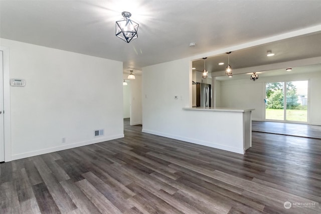 unfurnished living room featuring dark hardwood / wood-style floors