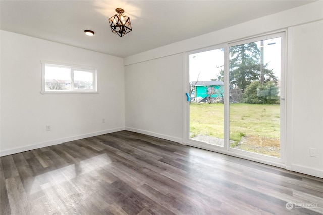 empty room with a healthy amount of sunlight and hardwood / wood-style flooring