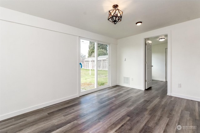 spare room with dark hardwood / wood-style flooring