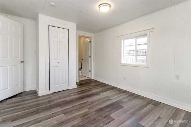 unfurnished bedroom featuring dark wood-type flooring