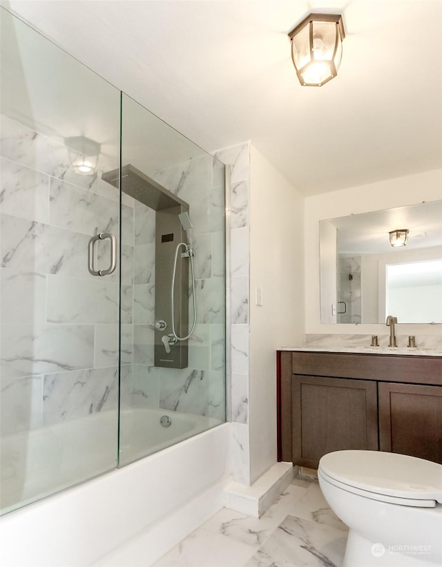 full bathroom with bath / shower combo with glass door, toilet, and vanity