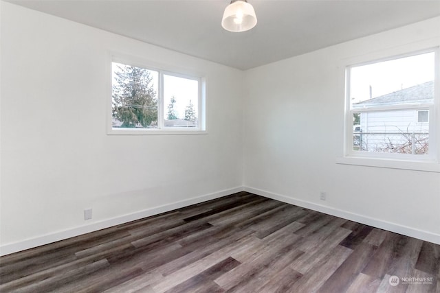 spare room featuring dark wood-type flooring