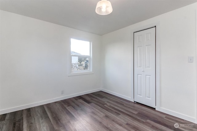 unfurnished room featuring dark hardwood / wood-style flooring