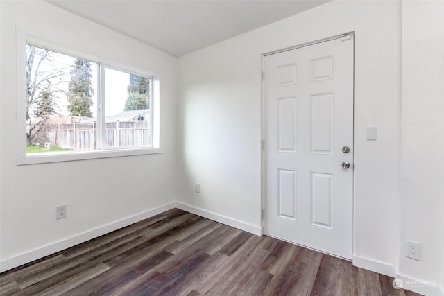 empty room with dark hardwood / wood-style floors