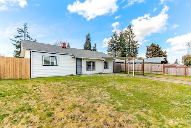 rear view of house with a yard