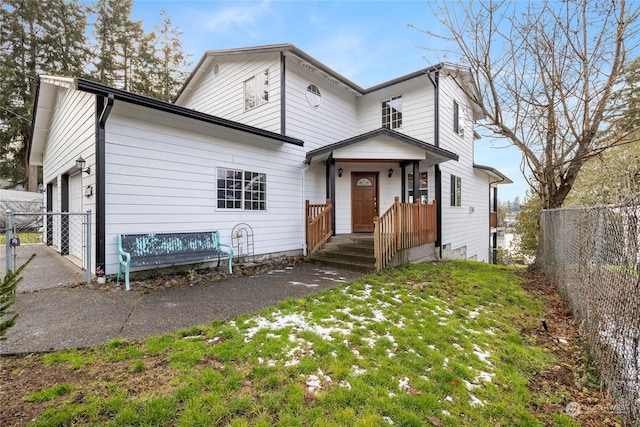 rear view of house featuring a garage