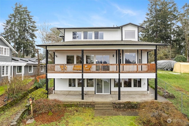 back of property featuring a yard and a patio