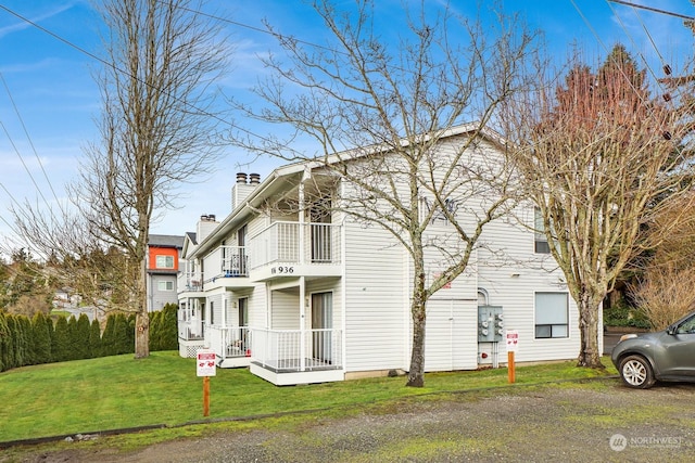 rear view of house with a yard