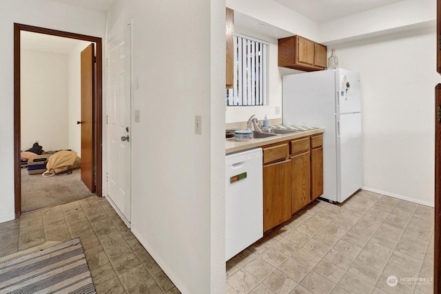 kitchen featuring sink and white appliances