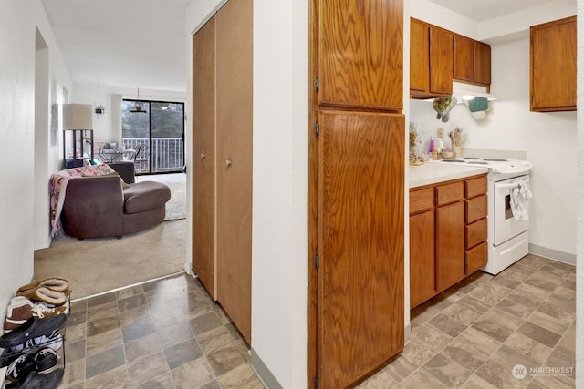 kitchen with light carpet and white electric range