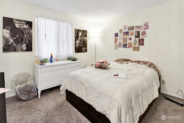 carpeted bedroom with a textured ceiling and multiple windows