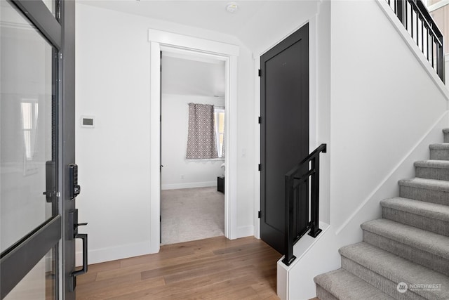 stairs with hardwood / wood-style floors