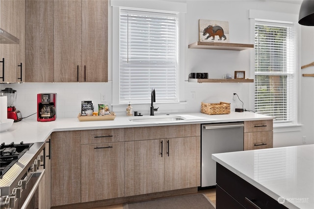 kitchen featuring dishwasher, sink, oven, and decorative backsplash