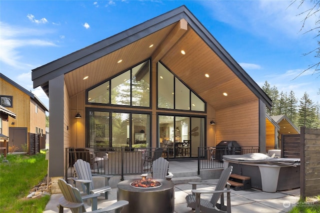 back of property featuring a patio area and an outdoor fire pit