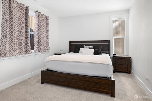 bedroom featuring light carpet