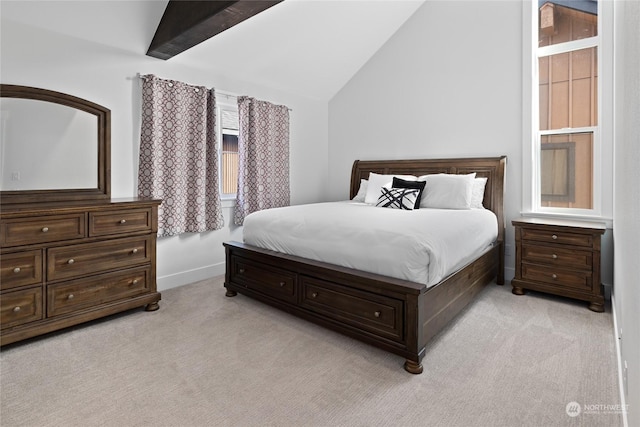 bedroom featuring lofted ceiling with beams and light colored carpet