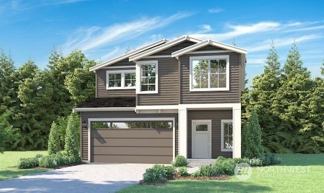 view of front of property featuring a garage and a front lawn