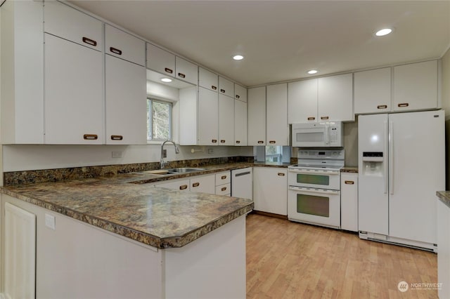 kitchen with white cabinets, light wood-type flooring, white appliances, and kitchen peninsula