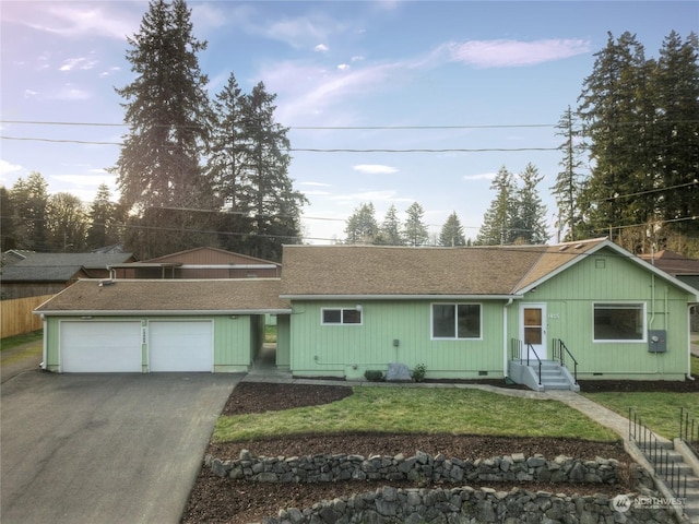 single story home with a garage and a front lawn