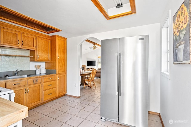 22214 Zenker Valley Rd SW, Centralia, WA 98531 - kitchen with high quality fridge, light tile patterned floors, decorative backsplash, ceiling fan, and lofted ceiling