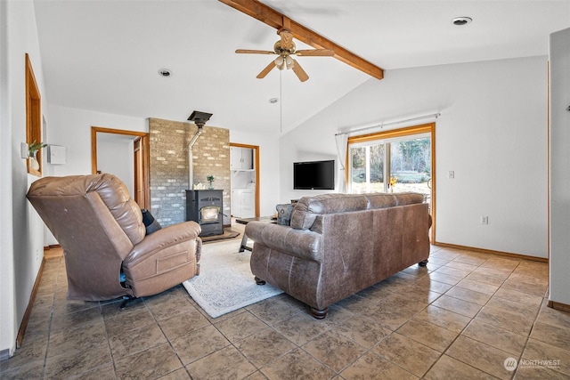 22214 Zenker Valley Rd SW, Centralia, WA 98531 - living room featuring ceiling fan, lofted ceiling with beams, a wood stove, and dark tile patterned floors