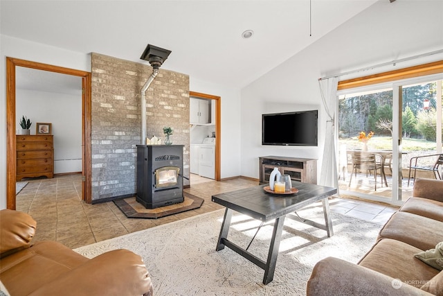 22214 Zenker Valley Rd SW, Centralia, WA 98531 - tiled living room with high vaulted ceiling, a wood stove, and washer / dryer