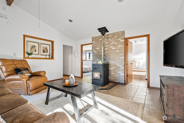 22214 Zenker Valley Rd SW, Centralia, WA 98531 - living room featuring a wood stove, vaulted ceiling, and light tile patterned floors