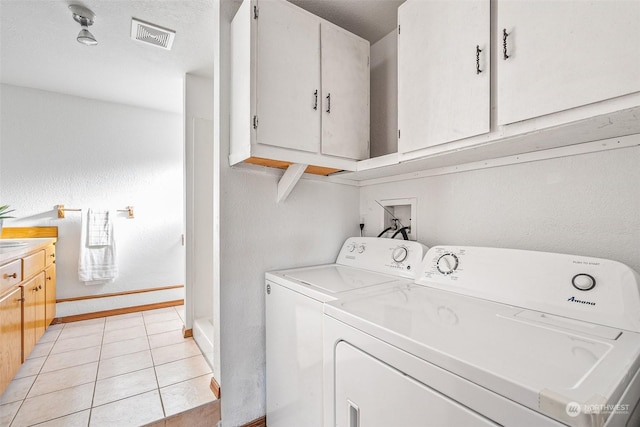 22214 Zenker Valley Rd SW, Centralia, WA 98531 - laundry room featuring cabinets, separate washer and dryer, and light tile patterned flooring
