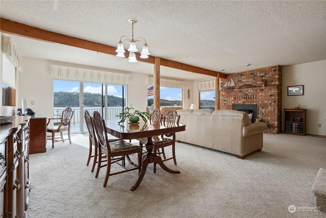 carpeted dining space featuring a notable chandelier, a brick fireplace, beam ceiling, and a textured ceiling