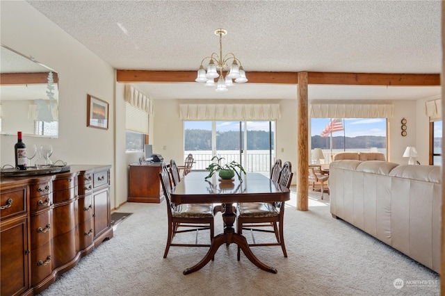 carpeted dining space with a textured ceiling, beamed ceiling, and an inviting chandelier