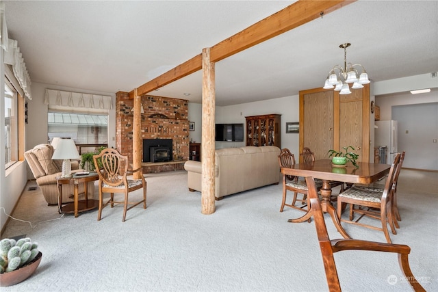 carpeted dining room featuring a notable chandelier and a fireplace