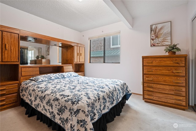 bedroom featuring light carpet, beamed ceiling, a textured ceiling, and multiple windows