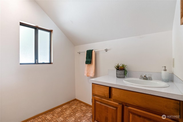 bathroom featuring vanity and vaulted ceiling