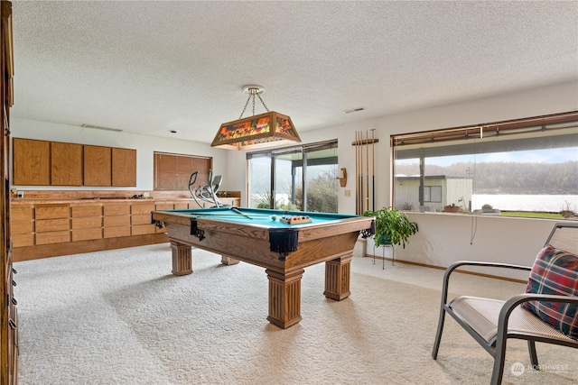 playroom with billiards, light colored carpet, and a textured ceiling