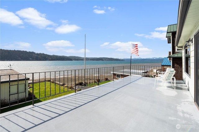 view of patio featuring a water view