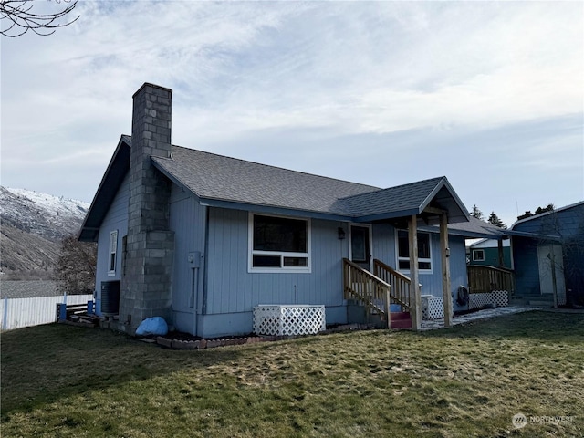 exterior space featuring cooling unit and a front lawn