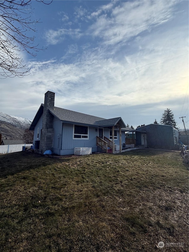 back of house featuring a lawn