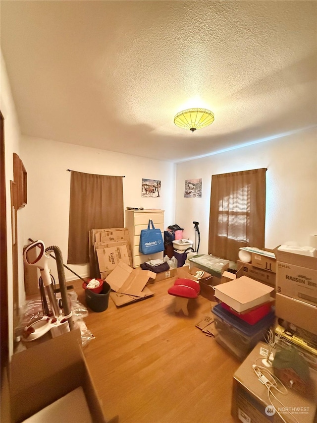 interior space with hardwood / wood-style floors and a textured ceiling