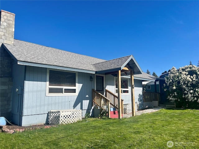 402 Kendall St, Riverside, WA 98849 - back of property with a shingled roof, a chimney, and a lawn