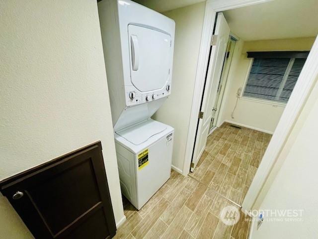 laundry area featuring stacked washer and dryer