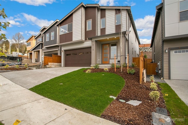 view of front of home with a garage and a front lawn