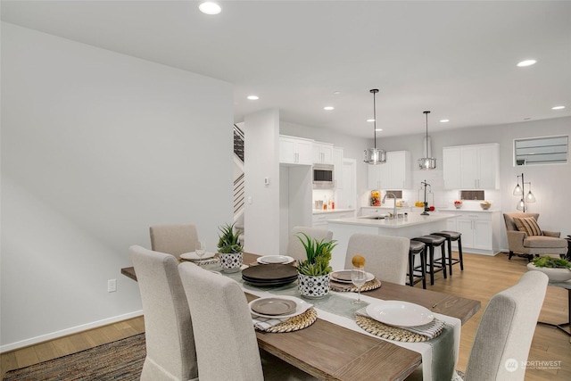 dining space featuring light hardwood / wood-style floors and sink