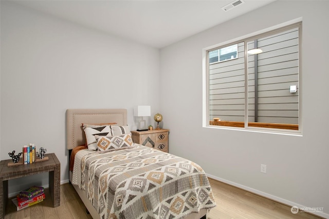 bedroom with hardwood / wood-style flooring