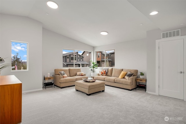 living room featuring plenty of natural light, light colored carpet, and vaulted ceiling