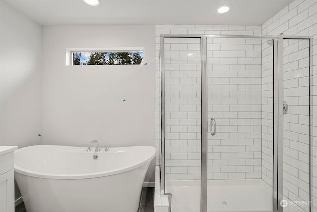 bathroom featuring vanity and plus walk in shower