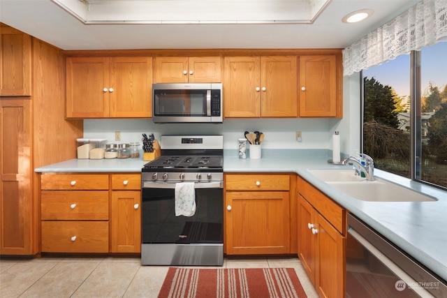 kitchen featuring sink, light tile patterned floors, and stainless steel appliances