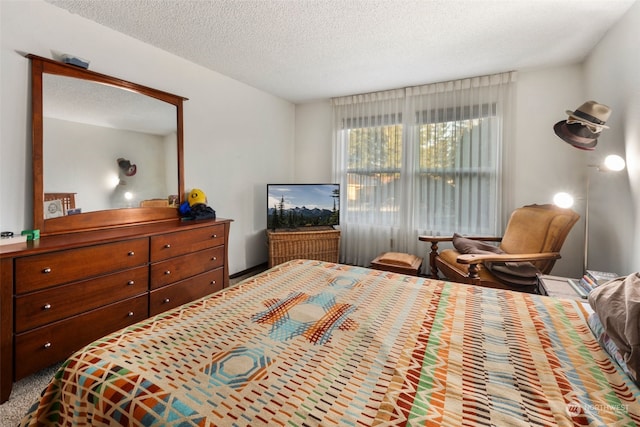 carpeted bedroom featuring a textured ceiling